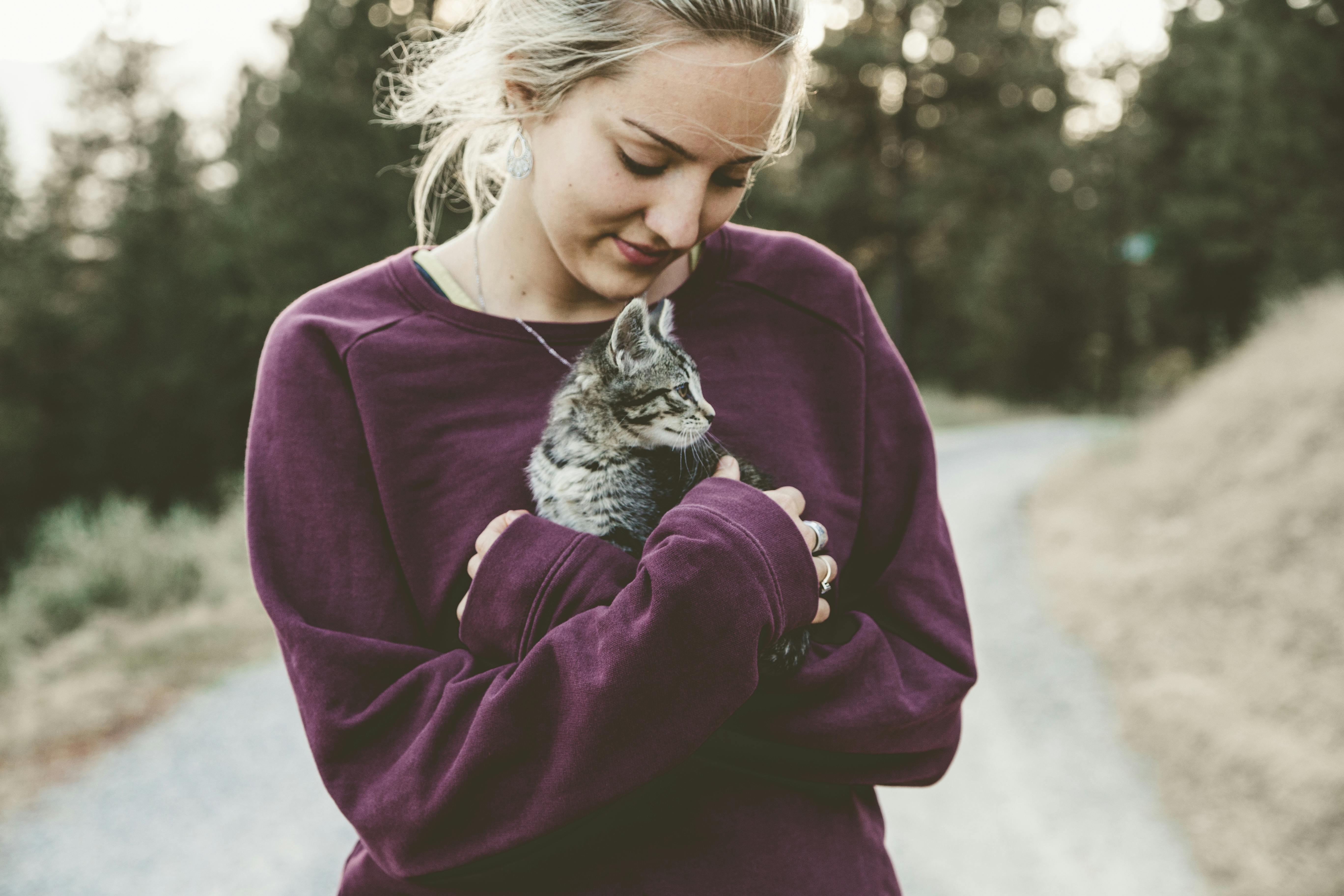 A woman holding a cat.